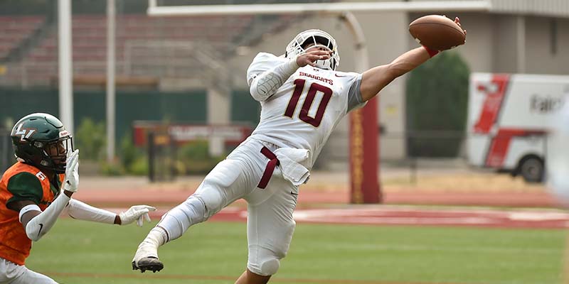 Justin Genovia makes a one-handed catch near the sideline against La Verne.