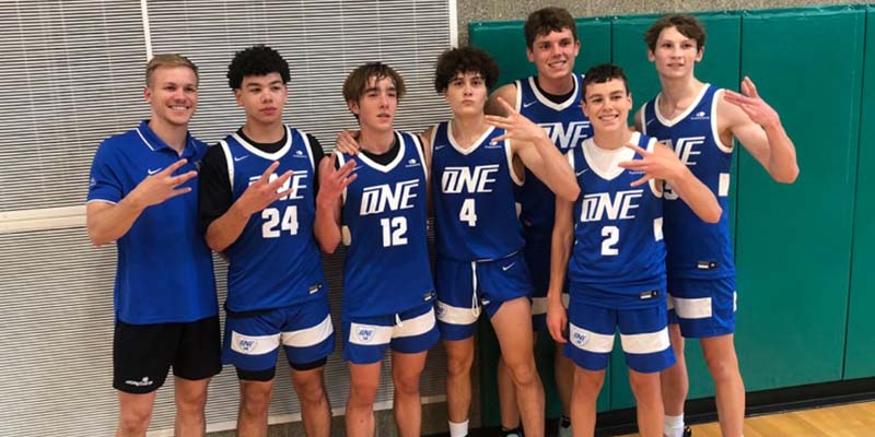 Jonathan Watts (Grad., W, San Diego, CA/Rancho Bernardo HS), left, with players on the boy's summer basketball team he coached