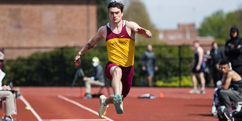 Oliver Anderson competes in the triple jump.