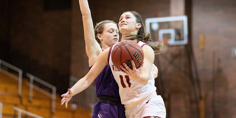Amanda Carpenter moves past a defender while shooting a layup for the Bearcats.
