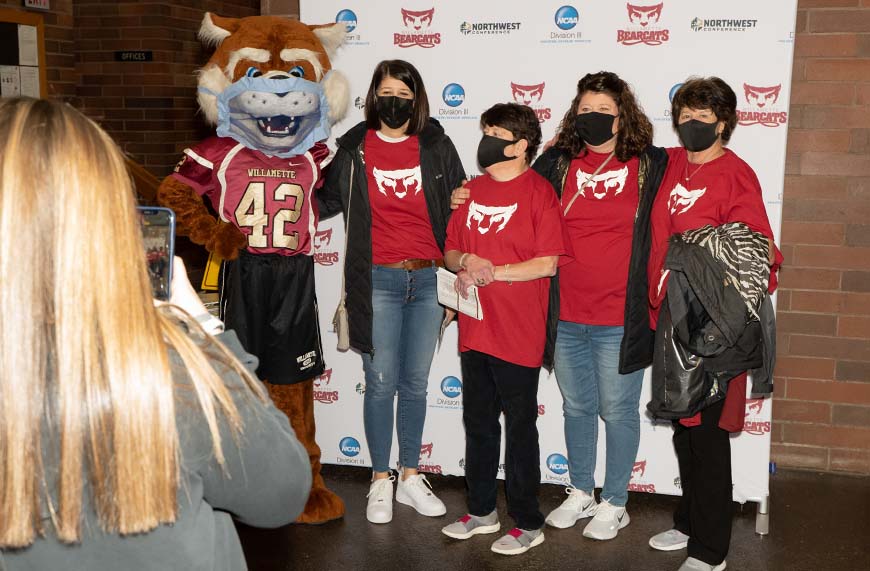 Bearcat mascot Blitz poses with members of Amanda Carpenter's family during Play for ABTA (American Brain Tumor Association) night.